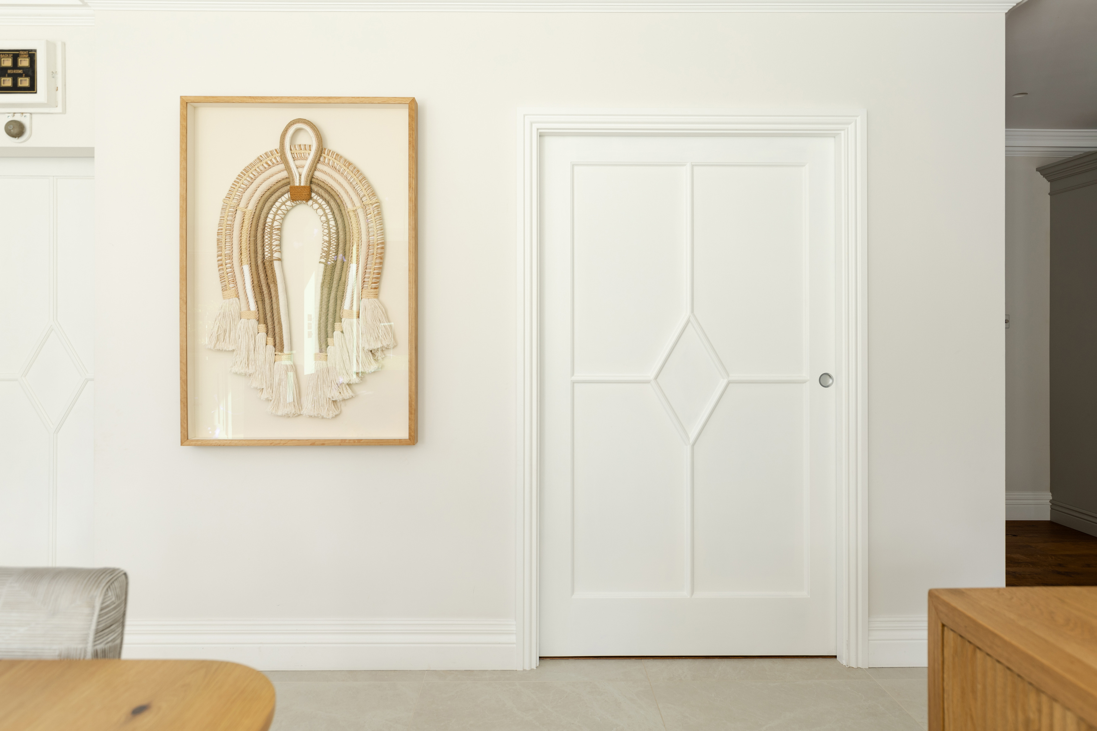 A wall with a painting and a Portman pocket door system