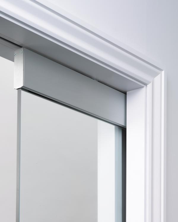 Frameless glass door kit requiring architrave